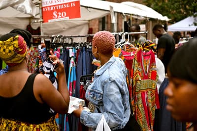 Vendors and visitors enjoying the vibrant marketplace atmosphere